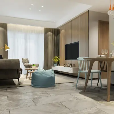 Modern living room featuring a gray sofa, light wood accents, a dining table set, and a bright atmosphere with large windows